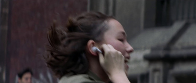 a woman talking on a cell phone while standing in front of a building