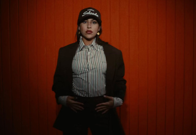 a woman standing in front of a red wall