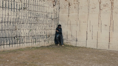 a person standing in front of a brick wall