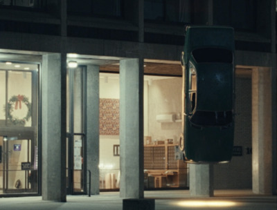 a car parked in front of a building at night