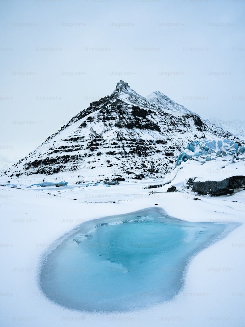 a mountain with a pool of water in the middle of it