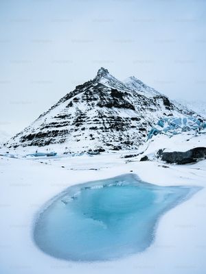 a mountain with a pool of water in the middle of it