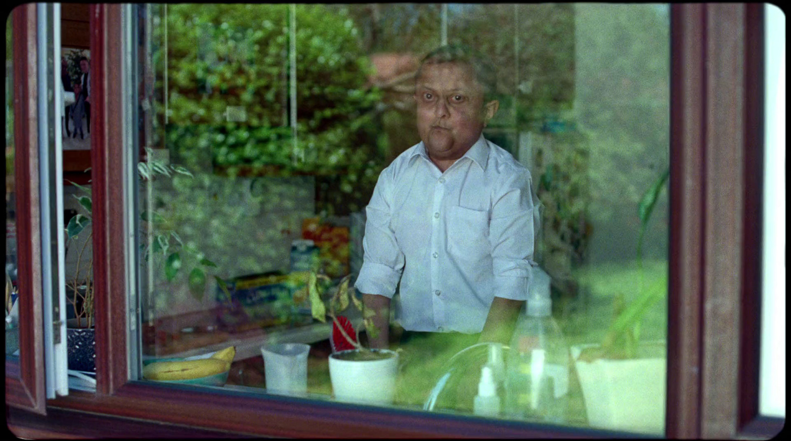 a man sitting at a table in front of a window