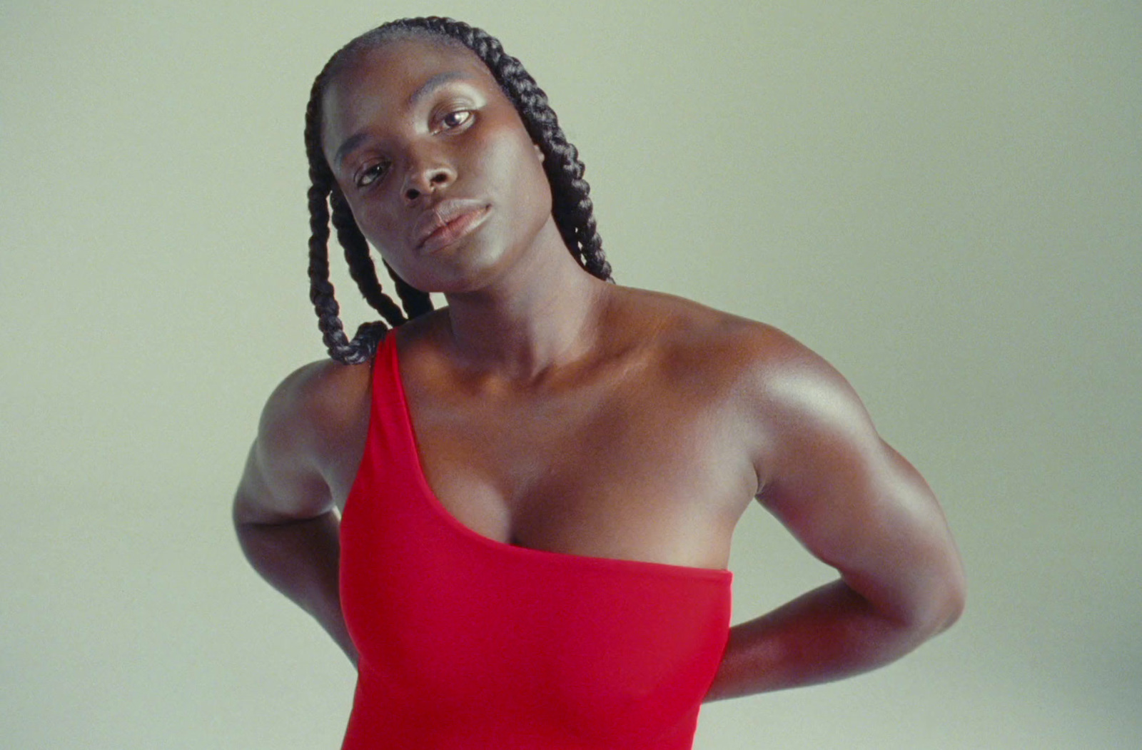 a woman in a red bodysuit posing for a picture