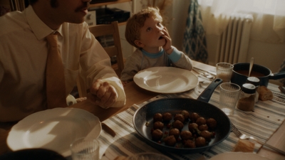 a man sitting at a table with a child