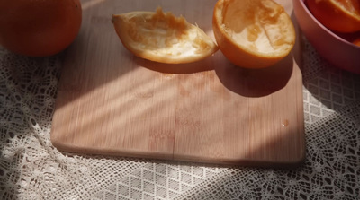 a wooden cutting board topped with sliced oranges