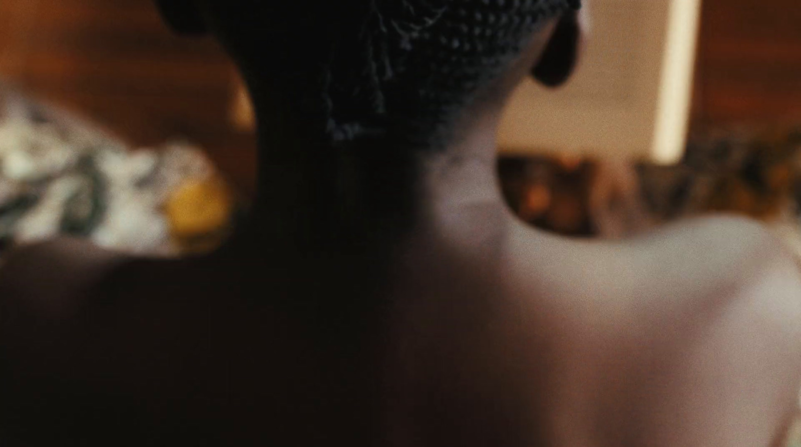 a close up of a woman's back with a hair comb in her hair