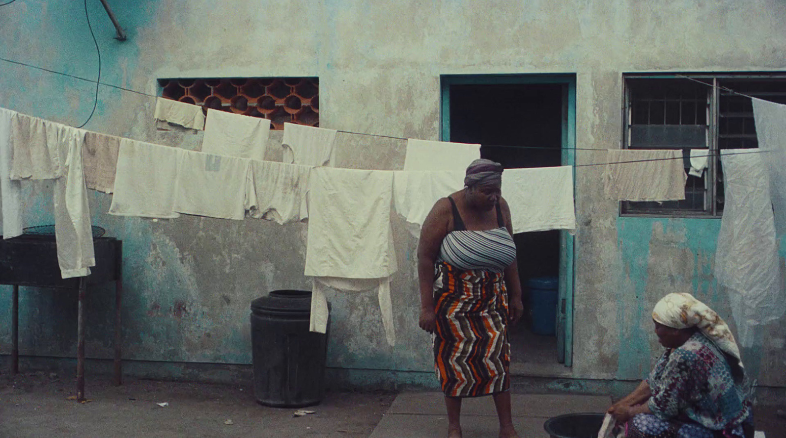 a woman standing next to a man on a sidewalk