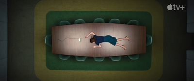 a person laying on a wooden floor in a room