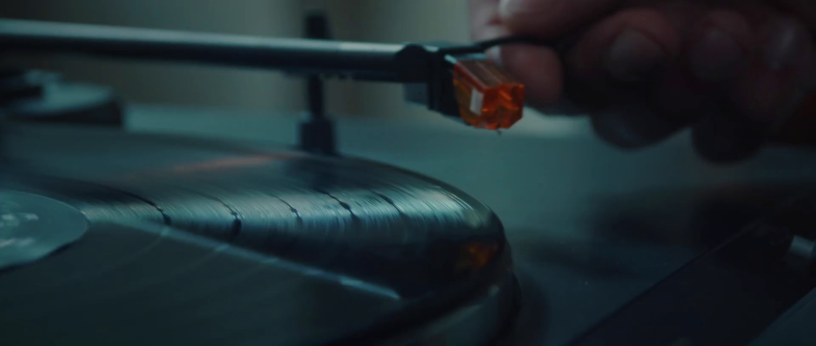 a close up of a person pressing a button on a record player