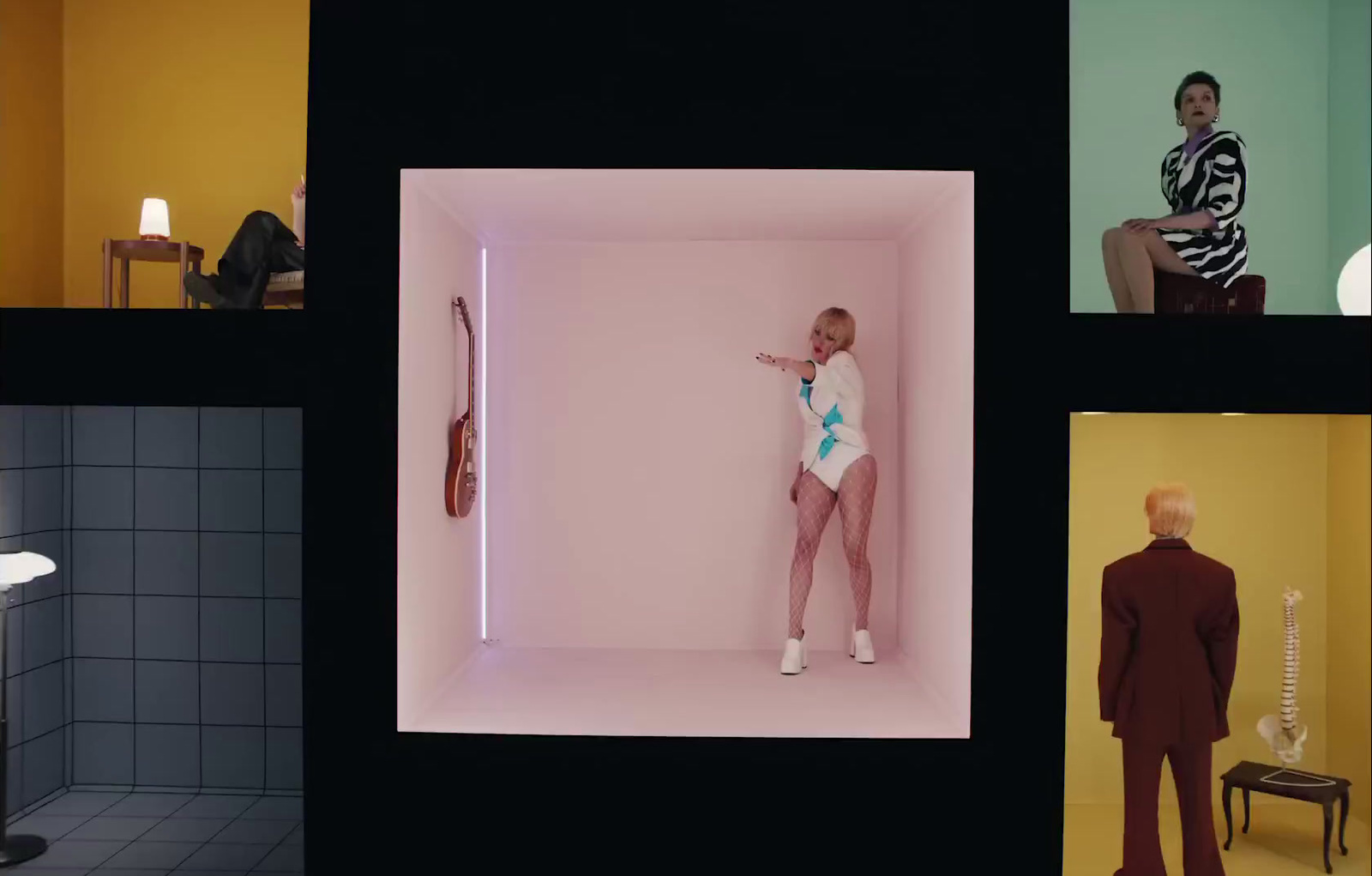 a man in a white bodysuit standing in a room