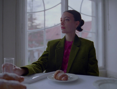 a woman sitting at a table with a plate of food