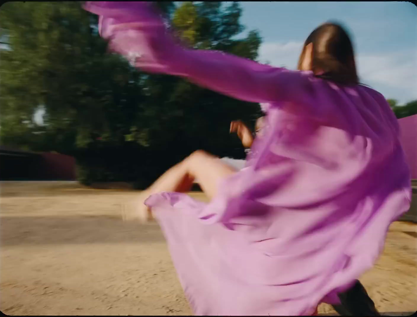 a woman in a purple dress is dancing