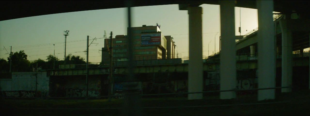 a view of a building through a fence