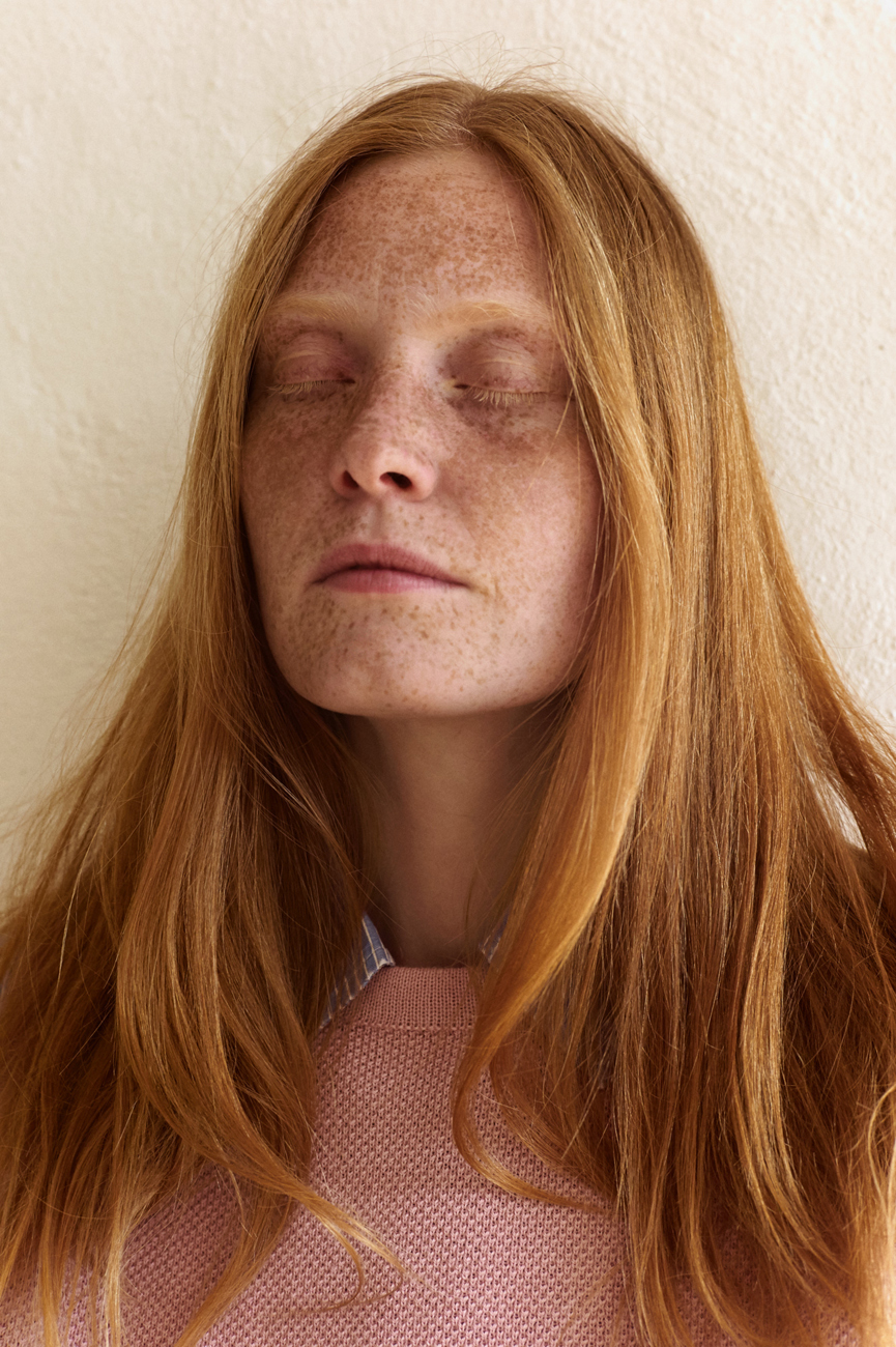 a close up of a person with freckled hair