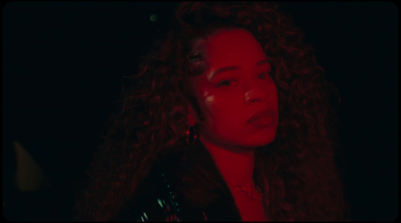 a close up of a person with curly hair