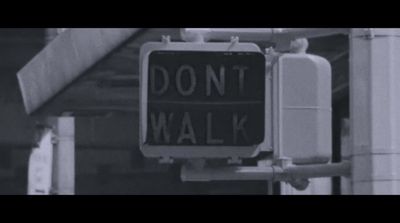 a black and white photo of a don't walk sign