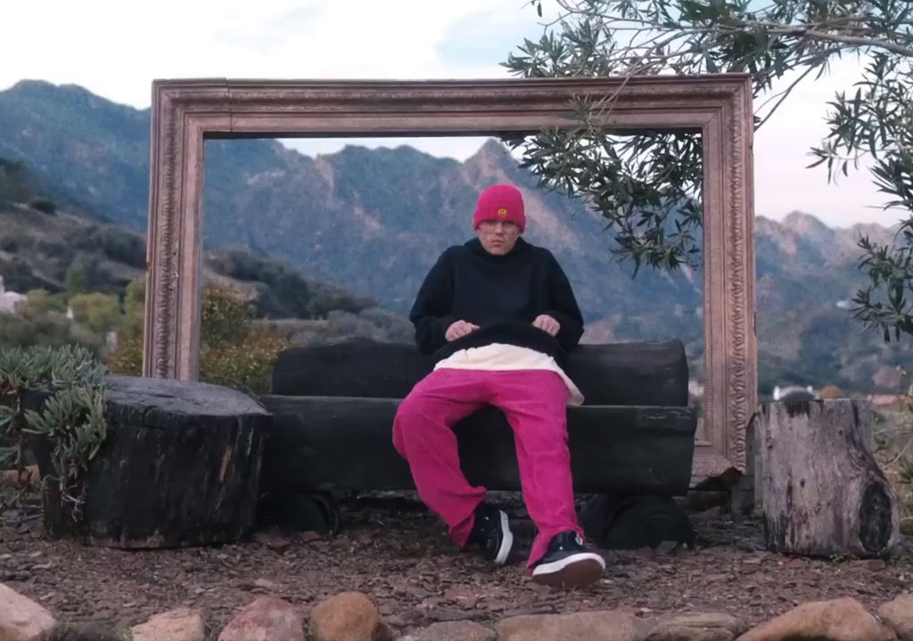 a person sitting on a bench in front of a mirror