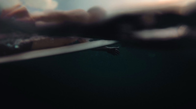 a blurry photo of a person holding a surfboard