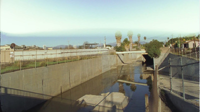 a view of a waterway with a bridge in the background