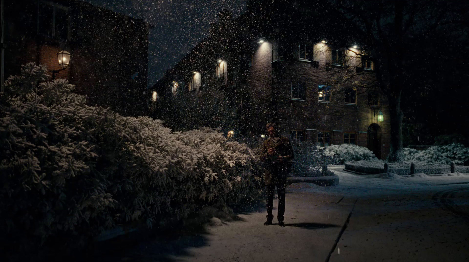 a person standing in the snow at night