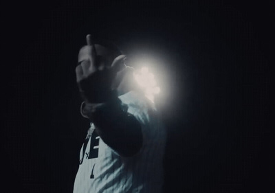 a baseball player holding a ball in the dark