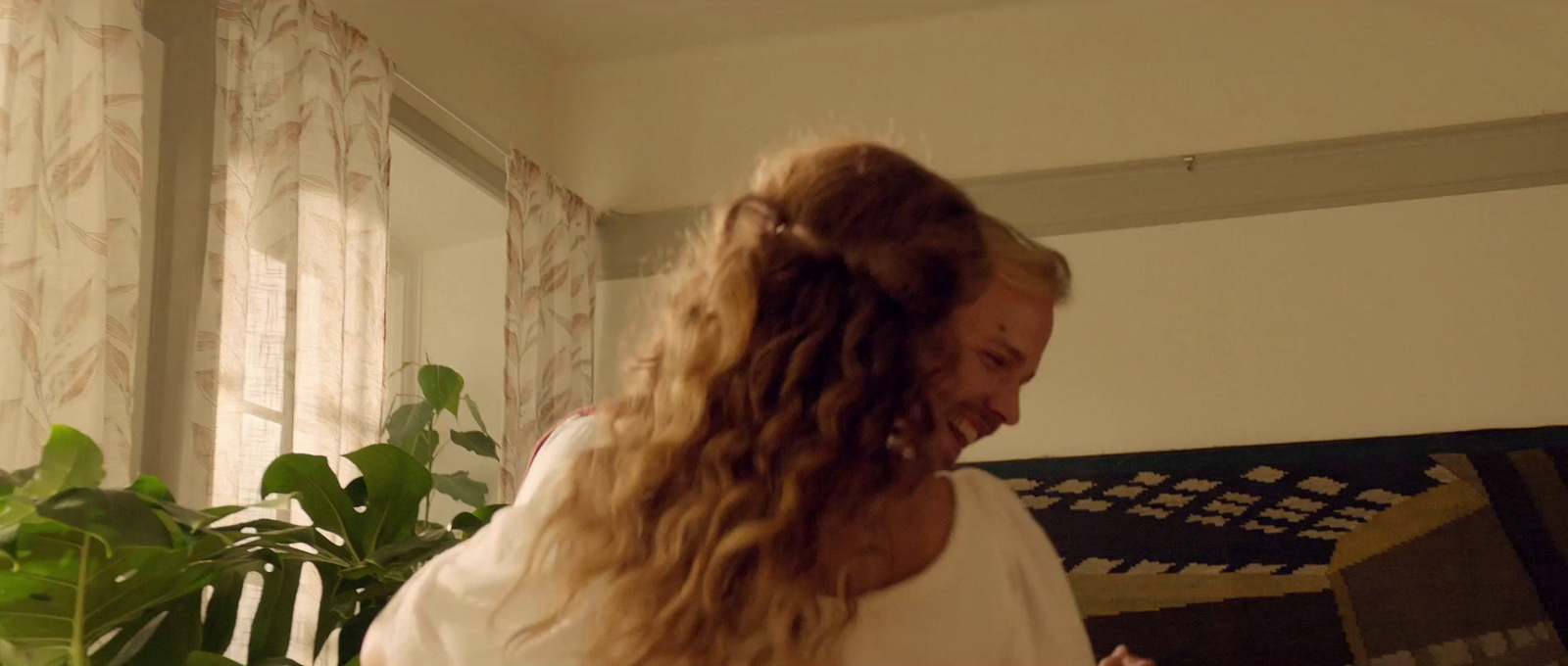 a woman with long hair standing in a room