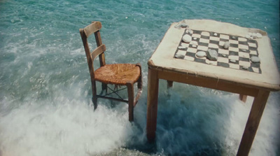 a table and a chair in the water