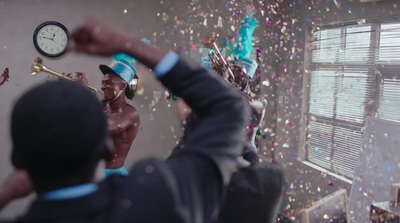 a group of people celebrating with confetti and a clock