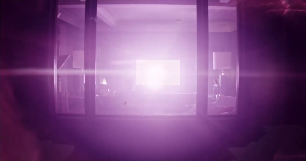 a room with a purple light coming through the window