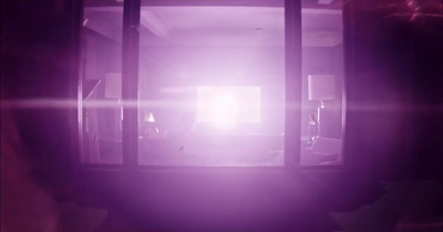 a room with a purple light coming through the window