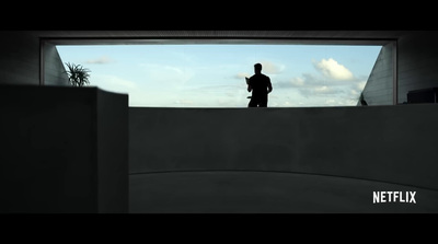 a man standing on top of a cement wall