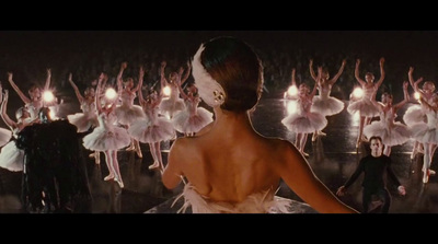 a woman in a white dress standing in front of a group of ballet dancers