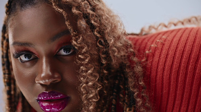 a close up of a person with long curly hair