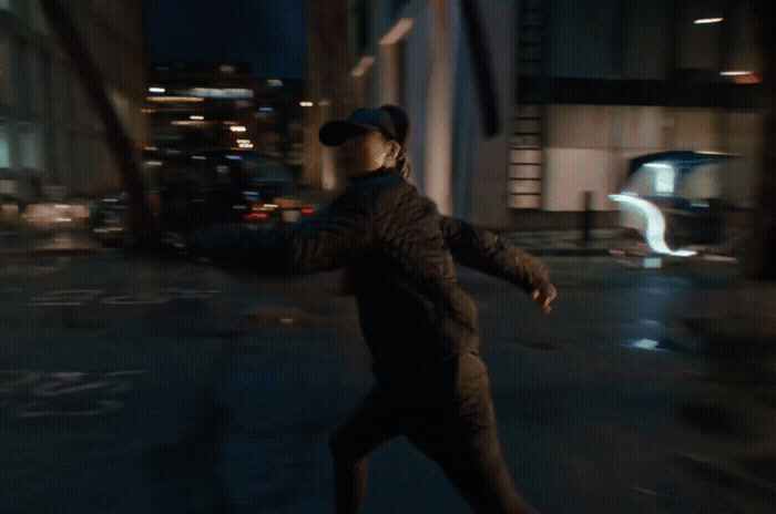 a man is skateboarding on a city street at night