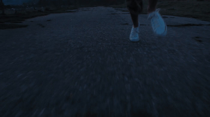 a person walking down a street at night