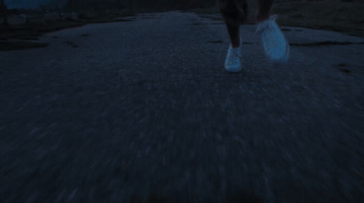 a person walking down a street at night