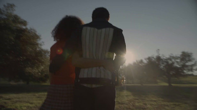 a man and a woman standing in a field