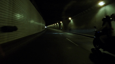 a person riding a scooter in a tunnel