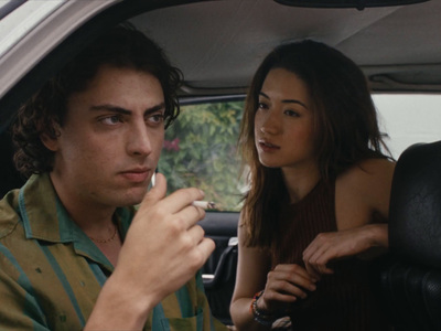 a man and a woman sitting in a car