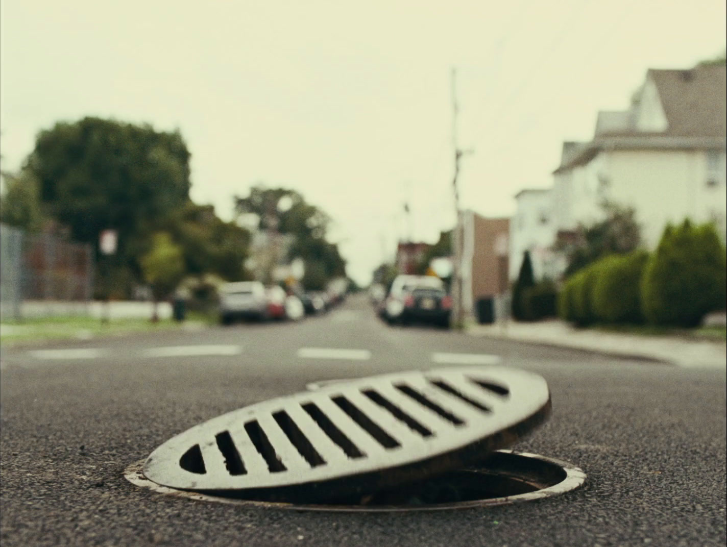 a manhole cover in the middle of a street