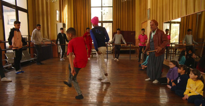 a group of people standing around a wooden floor