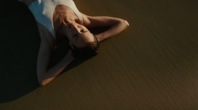 a man laying on the ground in a white shirt