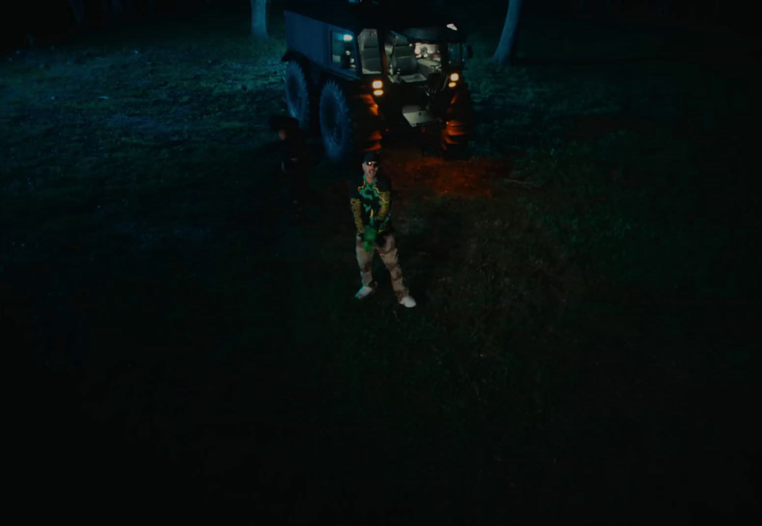 a man standing next to a truck in the dark