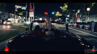 a woman sitting in the back of a car