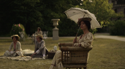 a woman sitting in a chair holding an umbrella