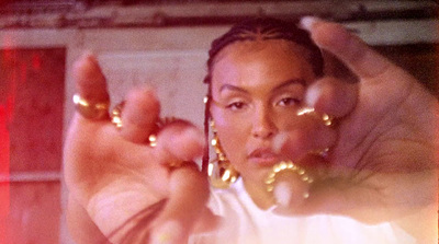 a woman in a white shirt and gold hoop earrings