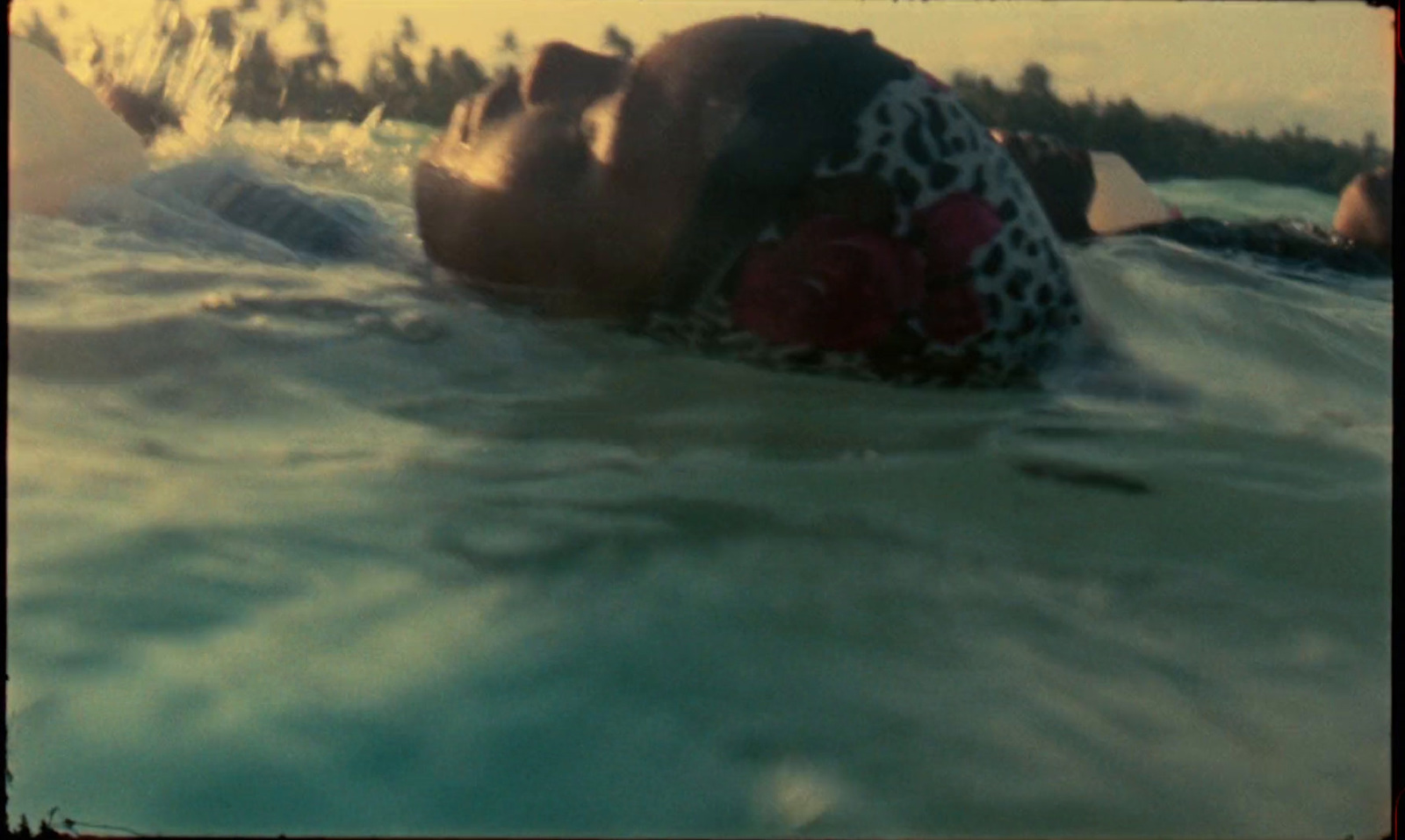 a man laying on top of a surfboard in the ocean