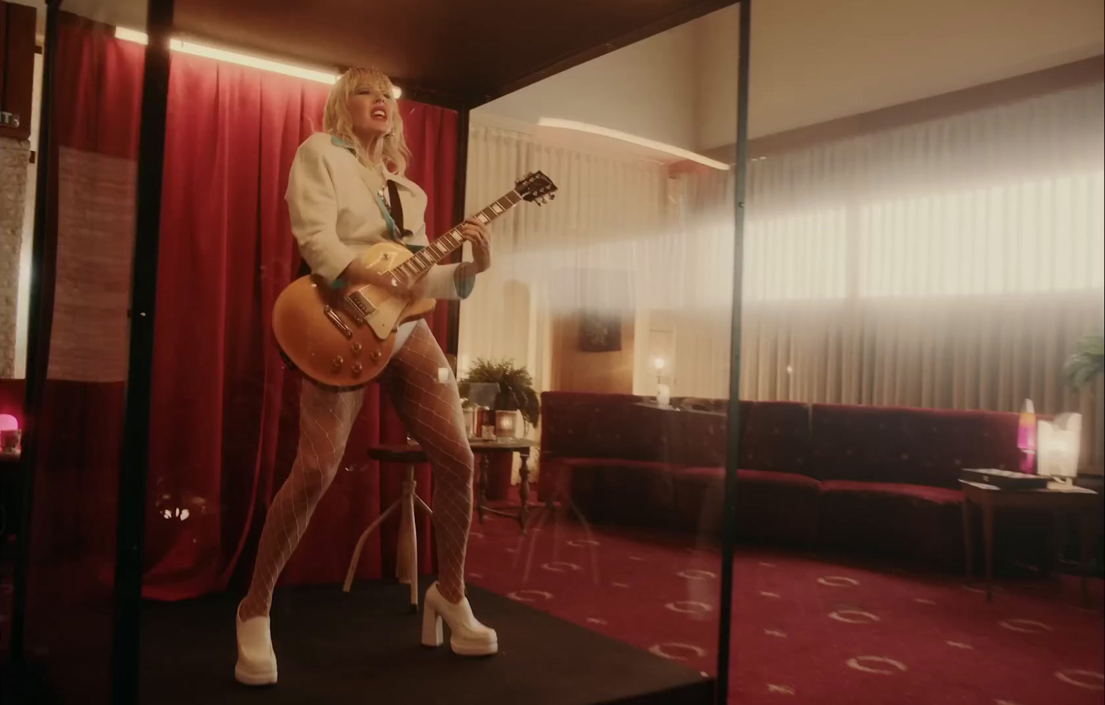 a woman playing a guitar in a room