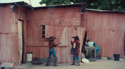 a couple of men standing next to a building